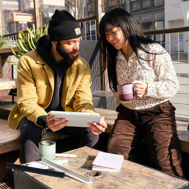 12oz-rise-mug-i3 12oz_rise_coffee_mug_dusty_orchid_couple_city_patio_square.jpg