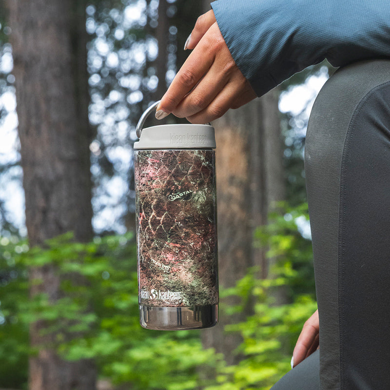 12oz-tkwide-with-cafe-cap-mossy-oak-z9 12oz_tumbler_mossyoak_rainbowtrout_hand_closeup_square.jpg