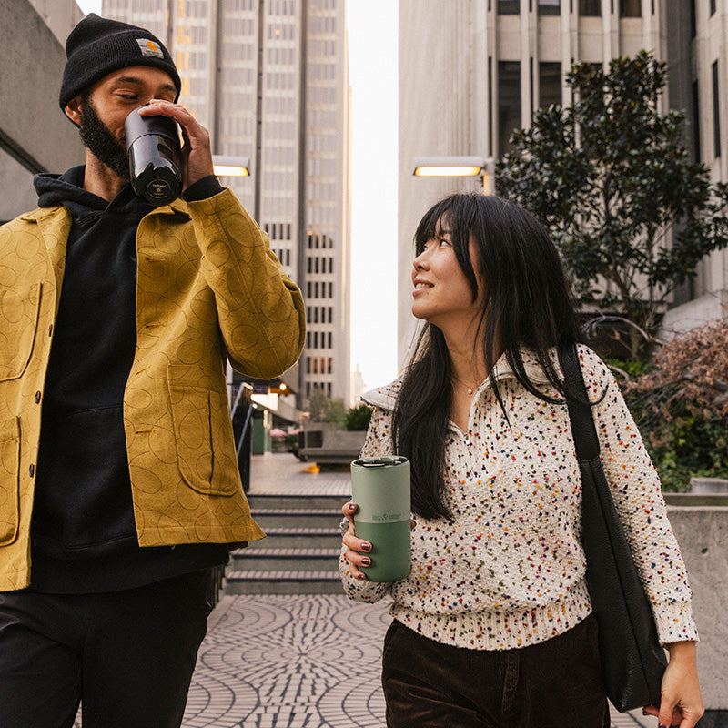 16oz-rise-tumbler-m5 16oz_rise_tumbler_black_iceberg_couple_drink_city_street_square.jpg