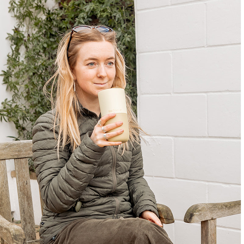 16oz-rise-tumbler-m5 16oz_rise_tumbler_wax_yellow_woman_seat_outside_square.jpg