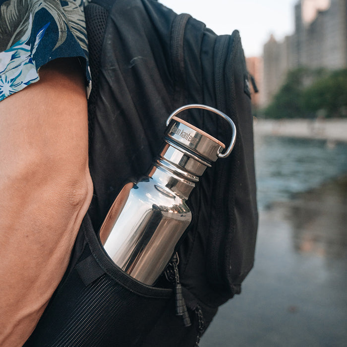 27oz-reflect-with-bamboo-cap-r0 K27SSLRF-MS-BAMBOO_reflect-bottle_backpack_lifestyle.jpg